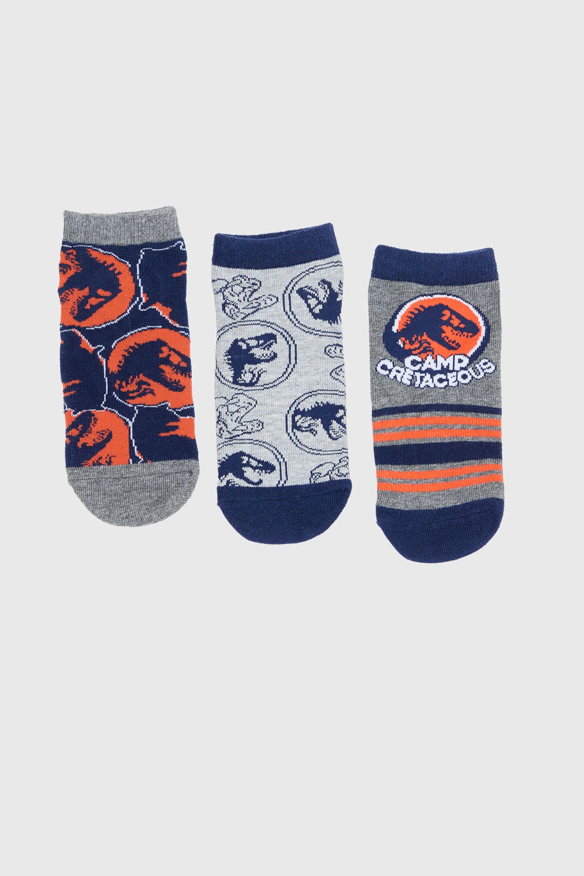 Calcetín niño azul con diseño de Jurassic World y dinosaurios.
