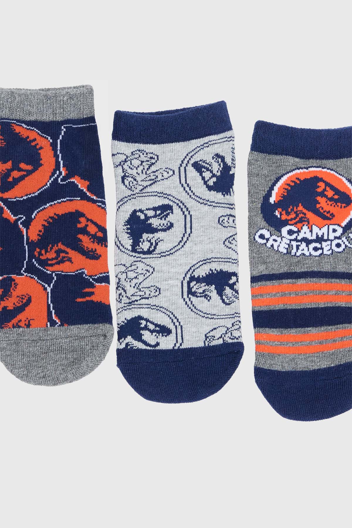 Calcetín niño azul con diseño de Jurassic World y dinosaurios.