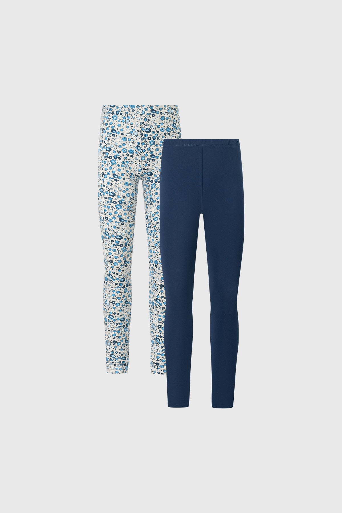 Bipack de calzas para niña en azul marino y diseño floral azul blanco calza lisa y estampada a la izquierda de tamaño completo