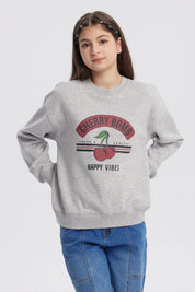 Polerón gris melange para niña con estampado Cherry Bomb en el frente mostrando cerezas y texto Happy Vibes