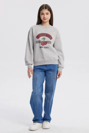 Polerón gris melange para niña con estampado Cherry Bomb en el frente mostrando cerezas y texto Happy Vibes