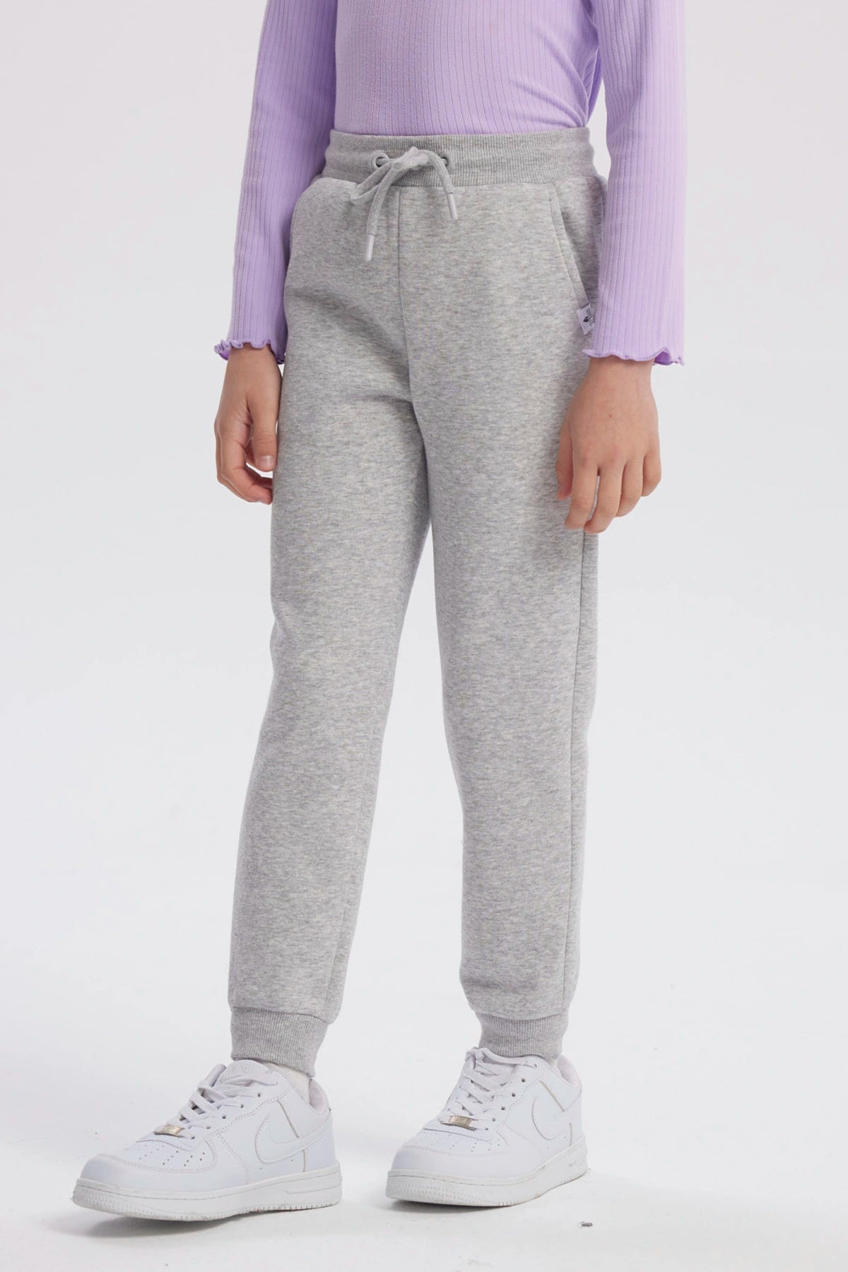 Pantalón jogger gris melange para niña con cintura ajustable y puños elásticos diseño liso ideal para comodidad diaria