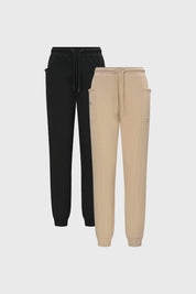 Pantalón buzo beige y negro para niña con bolsillos laterales diseño liso estilo casual ideal para días relajados