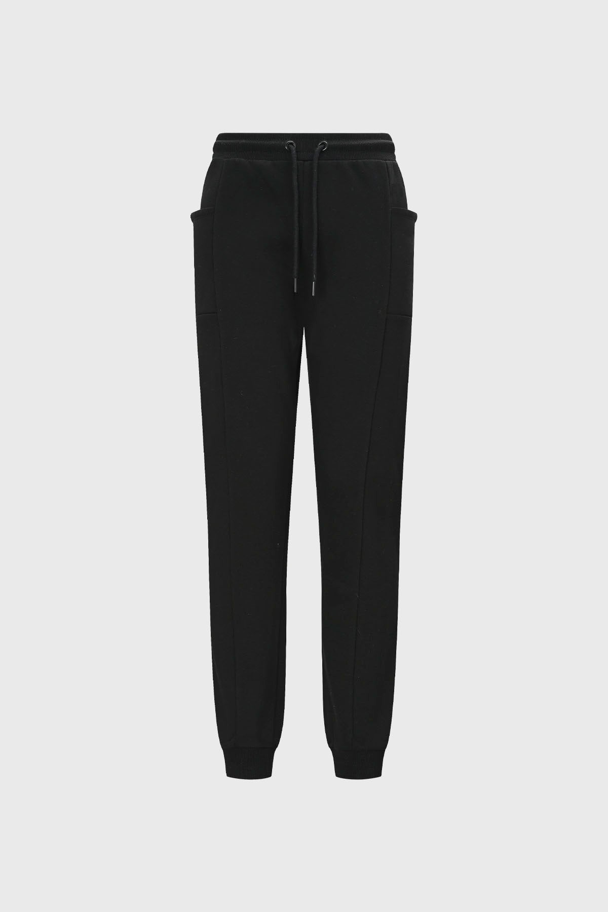 Pantalón buzo beige y negro para niña con bolsillos laterales diseño liso estilo casual ideal para días relajados