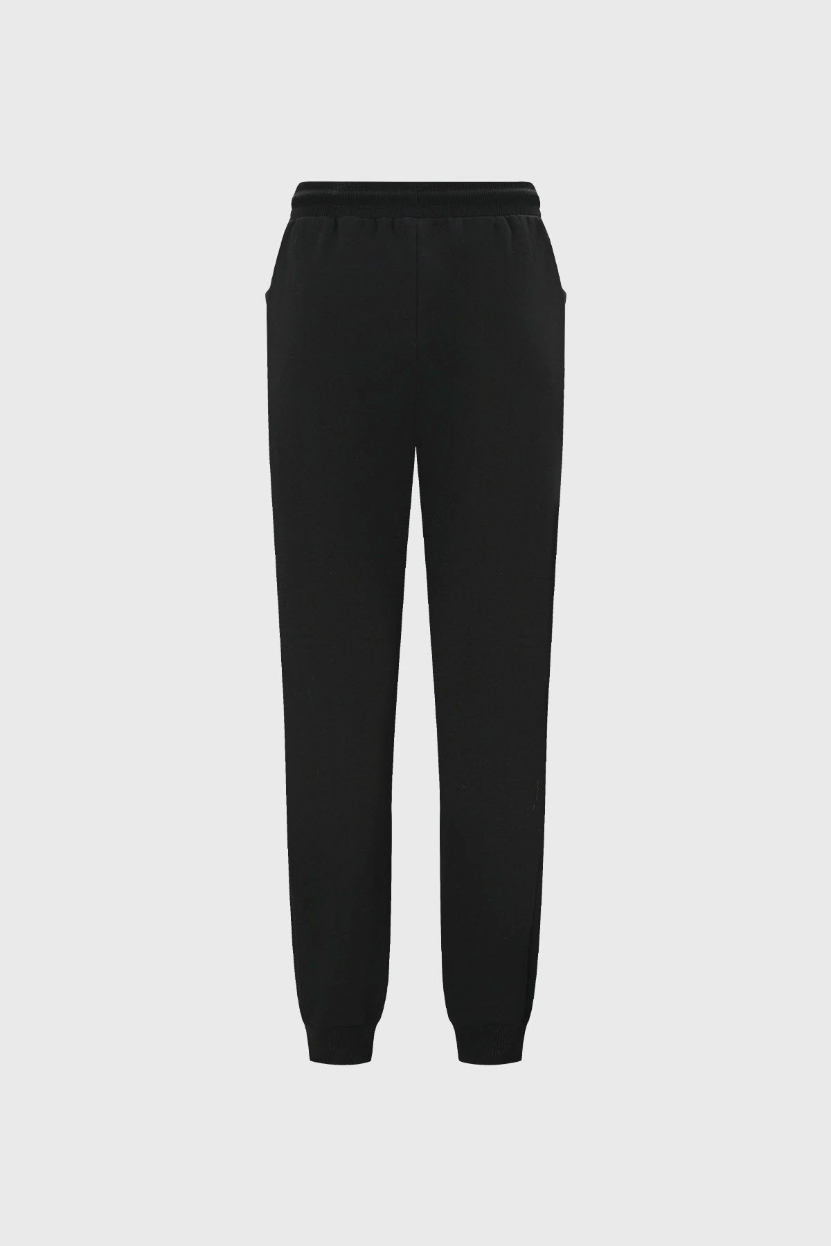 Pantalón buzo beige y negro para niña con bolsillos laterales diseño liso estilo casual ideal para días relajados