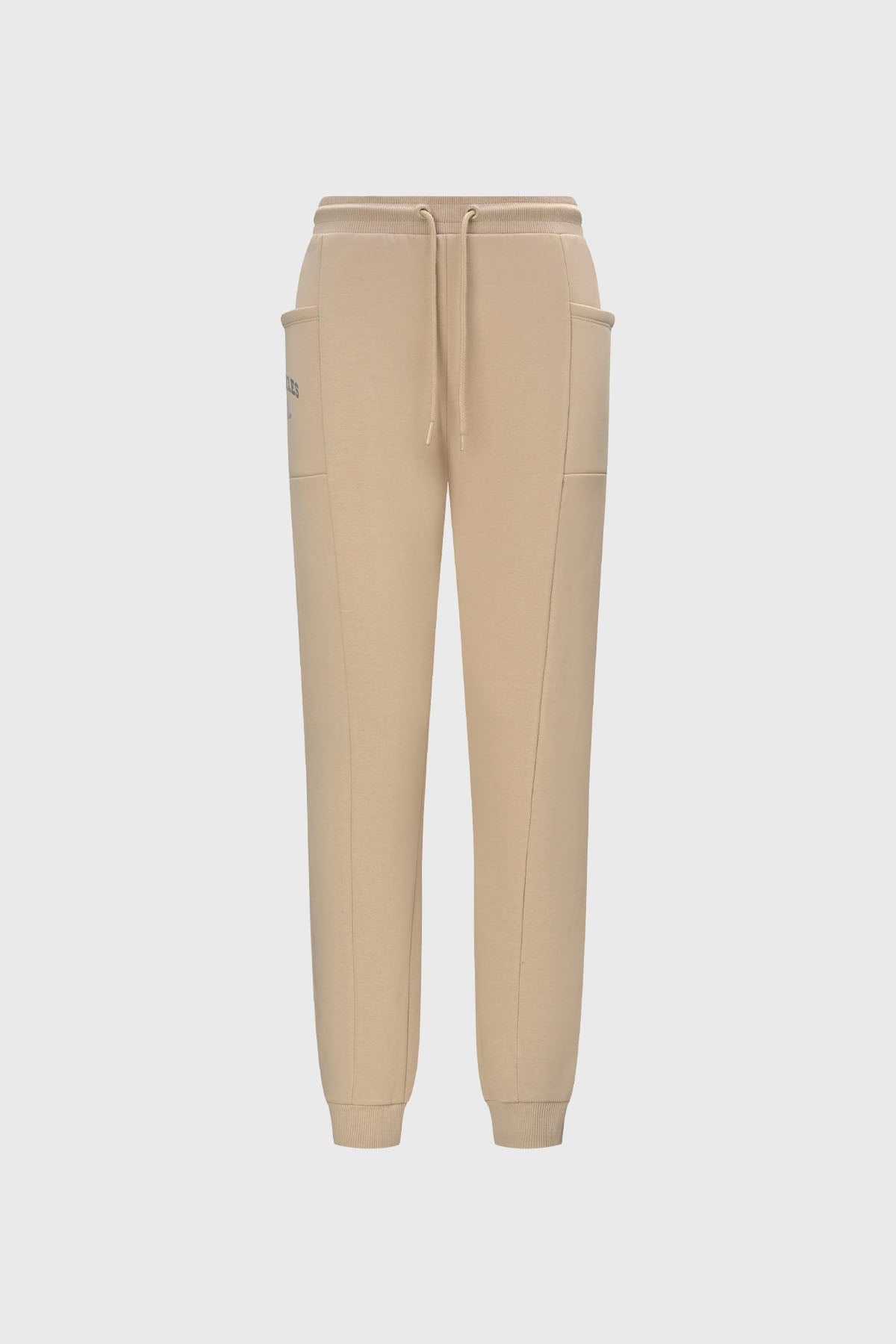 Pantalón buzo beige y negro para niña con bolsillos laterales diseño liso estilo casual ideal para días relajados