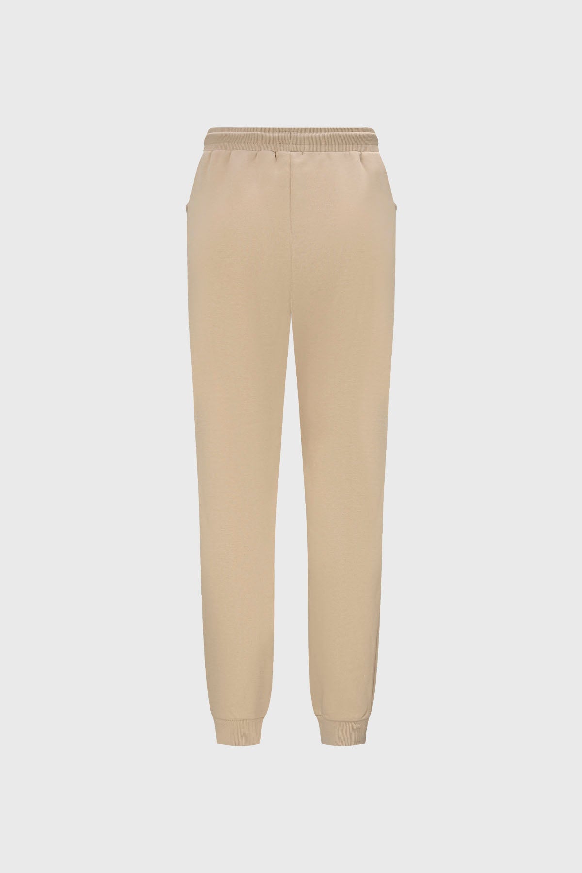 Pantalón buzo beige y negro para niña con bolsillos laterales diseño liso estilo casual ideal para días relajados