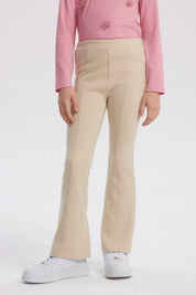 Calza flare beige para niña con diseño acampanado lisa sin estampa perfecta para combinar con cualquier prenda casual
