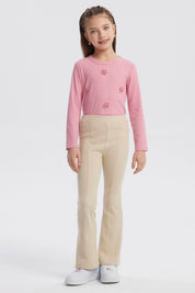Calza flare beige para niña con diseño acampanado lisa sin estampa perfecta para combinar con cualquier prenda casual