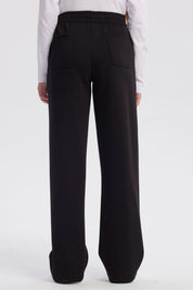 Pantalón buzo negro para niña con pierna ancha sin estampa visible diseño liso y cintura elástica para comodidad
