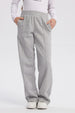 Pantalón buzo gris melange para niña con corte wide leg y bolsillos laterales sin estampa visible