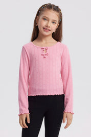 Polera de niña rosada con lazos y pequeños corazones en toda la prenda diseño delicado y manga larga