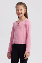 Polera de niña rosada con lazos y pequeños corazones en toda la prenda diseño delicado y manga larga