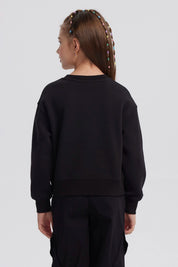 Polerón negro para niña con diseño de strass formando las letras NY en el pecho estilo casual y moderno