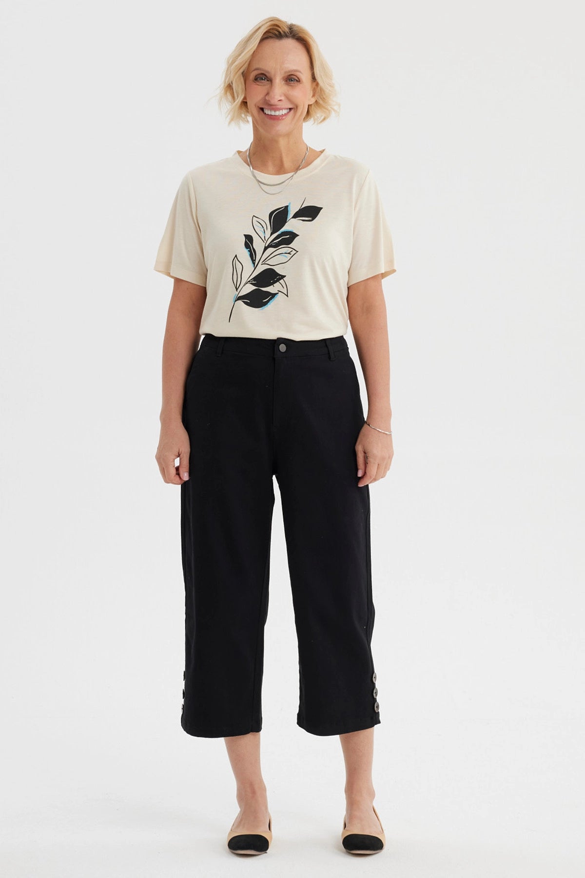 Pantalón pescador negro mujer con botones laterales en los bajos y detalle de pretina lisa elegante