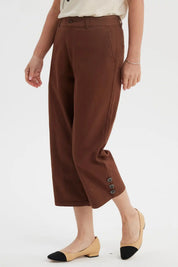 Pantalón pescador café para mujer con detalle de botones en la pretina y diseño liso ideal para un look casual