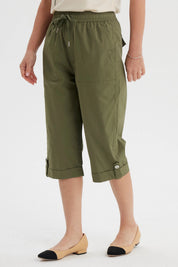 Pantalón pescador verde olivo con cortes y aperturas diseño liso ajuste elástico y bolsillos delanteros grandes