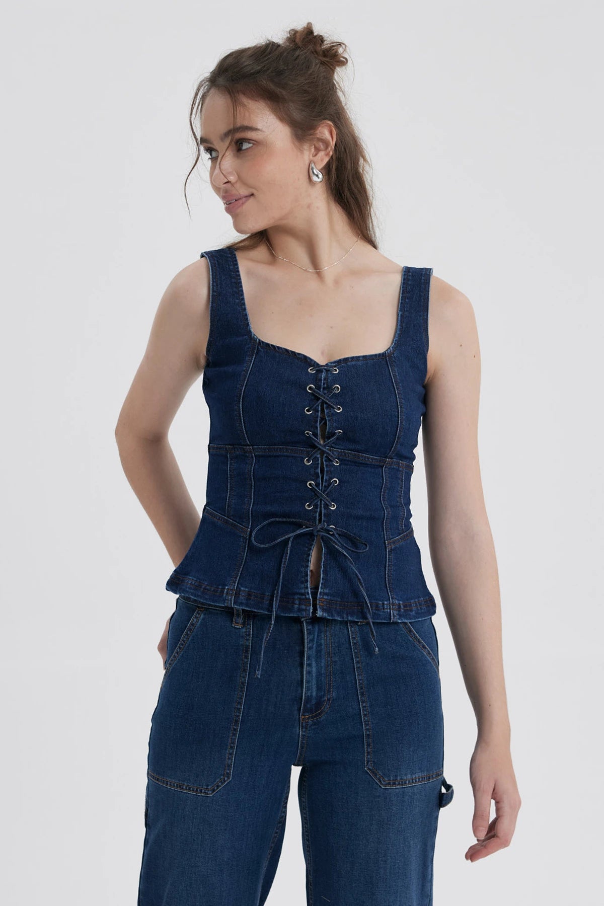 Peto Mujer Corse Peplum Azul con diseño corsé y detalles de cordones frontales