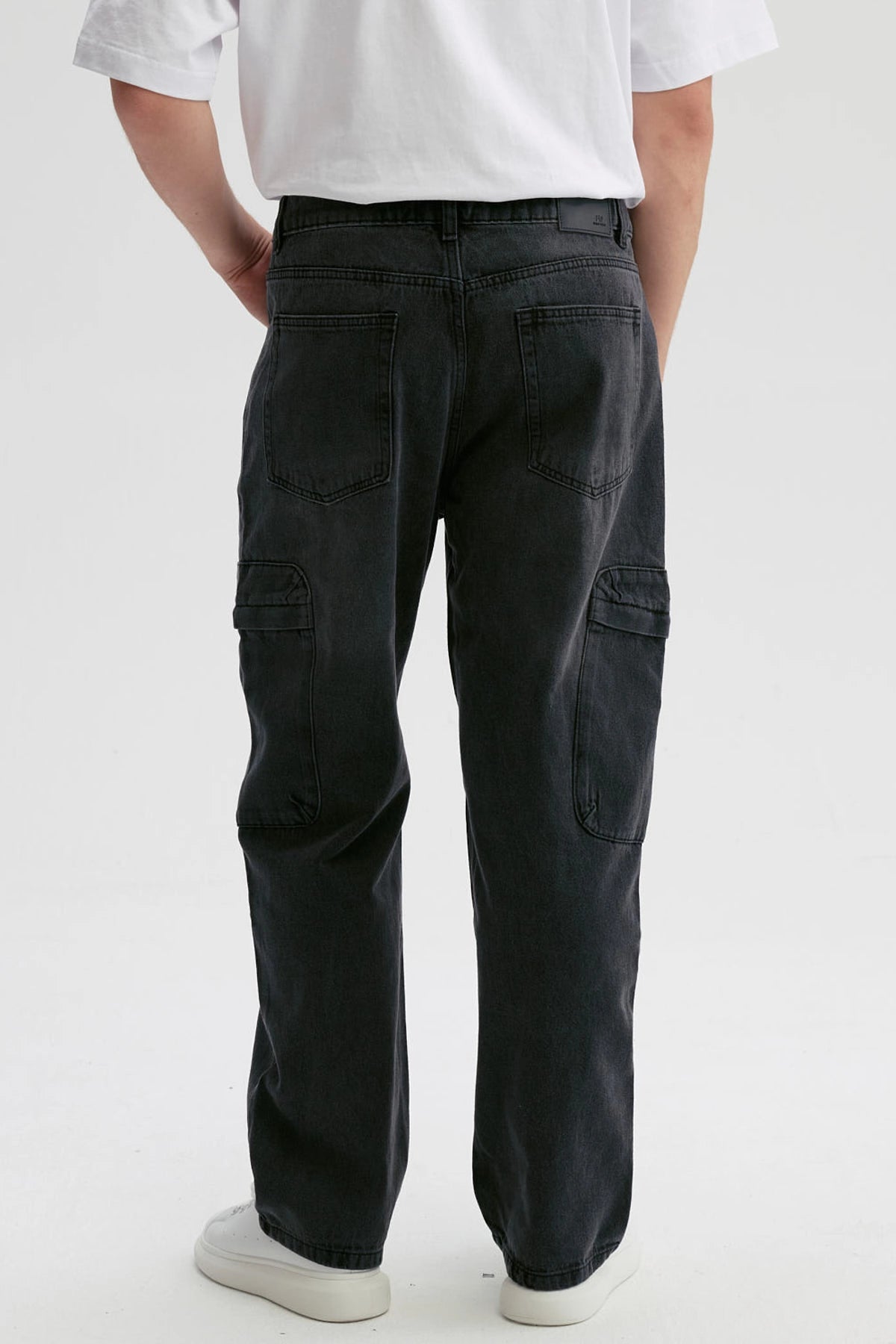 Jeans negros de hombre estilo baggy cargo con bolsillos laterales visibles