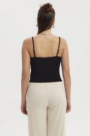 Peto negro mujer con textura y encaje en escote sin estampa lisa elegante