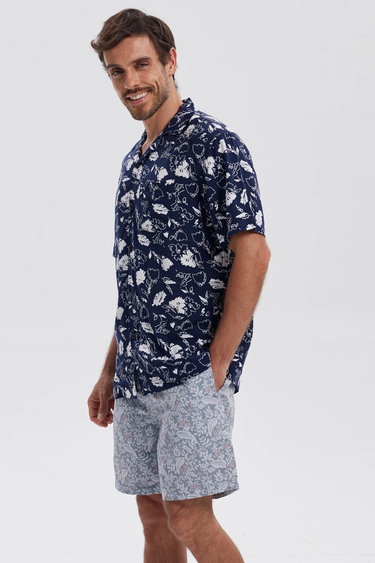 Camisa azul marino de hombre con estampado floral blanco en toda la prenda estilo casual relajado