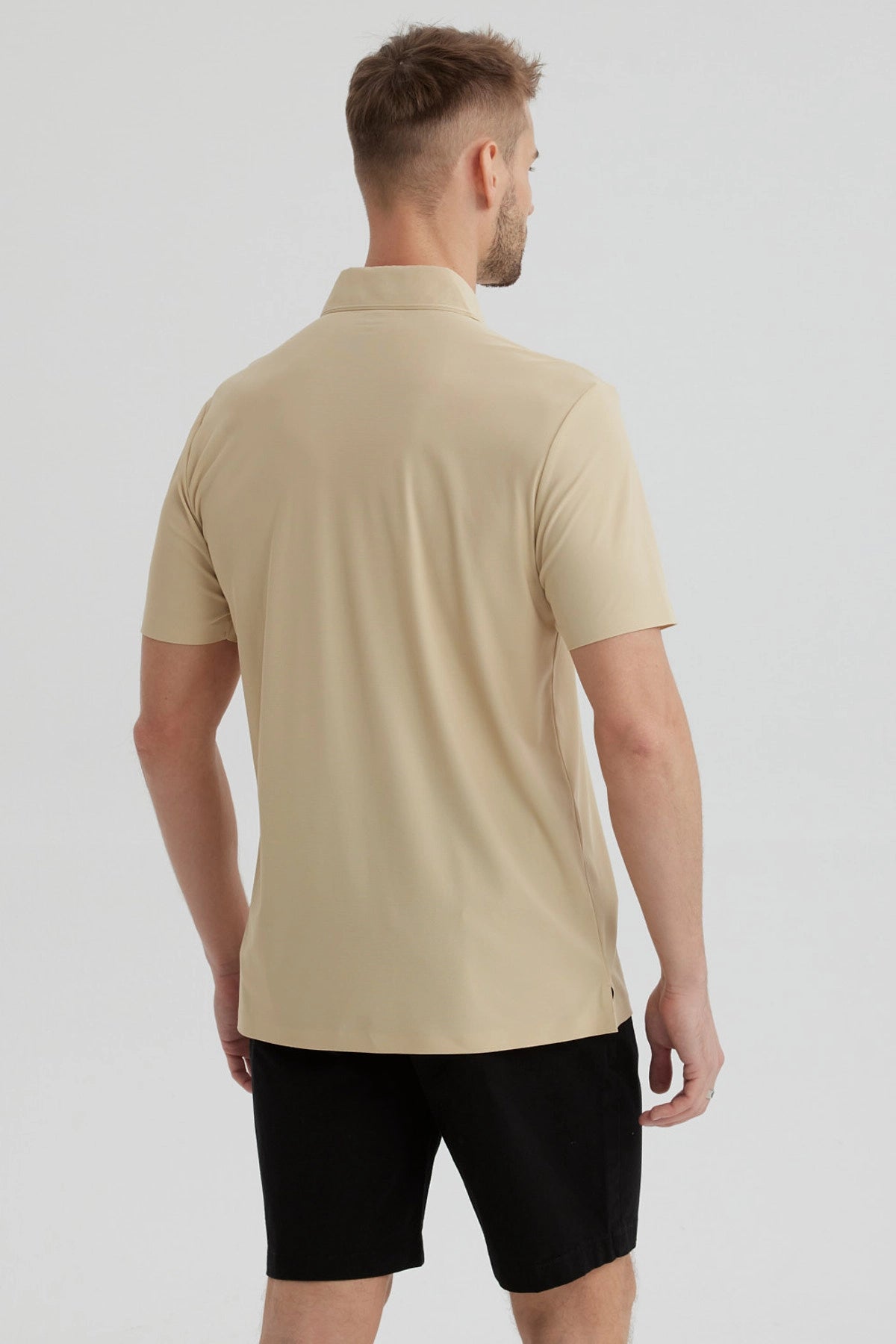 Polera técnica beige para hombre con cuello polo y botón frontal diseño liso ideal para estilo casual y moderno