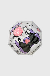Paraguas violeta con diseño de Kuromi en estilo animado cubriendo toda la superficie con detalles de estrellas y corazones