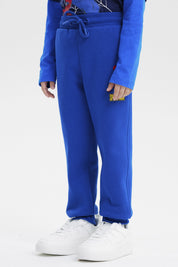 Pantalón buzo niño azul marino con dibujo de Spider-Man pequeño en la pierna derecha estilo cómic