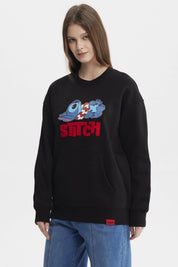 Polerón negro de mujer con estampado de Stitch recostado al frente estilo caricatura grande con texto rojo STITCH