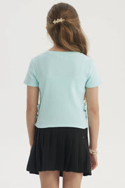 Polera calipso para niña con cinta decorativa en los costados lisa de manga corta ideal para días cálidos