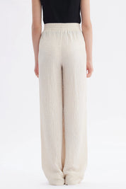 Pantalón niña wide leg beige textura lisa con cintura elástica y caída amplia hasta los tobillos