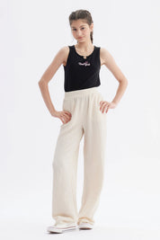 Pantalón niña wide leg beige textura lisa con cintura elástica y caída amplia hasta los tobillos
