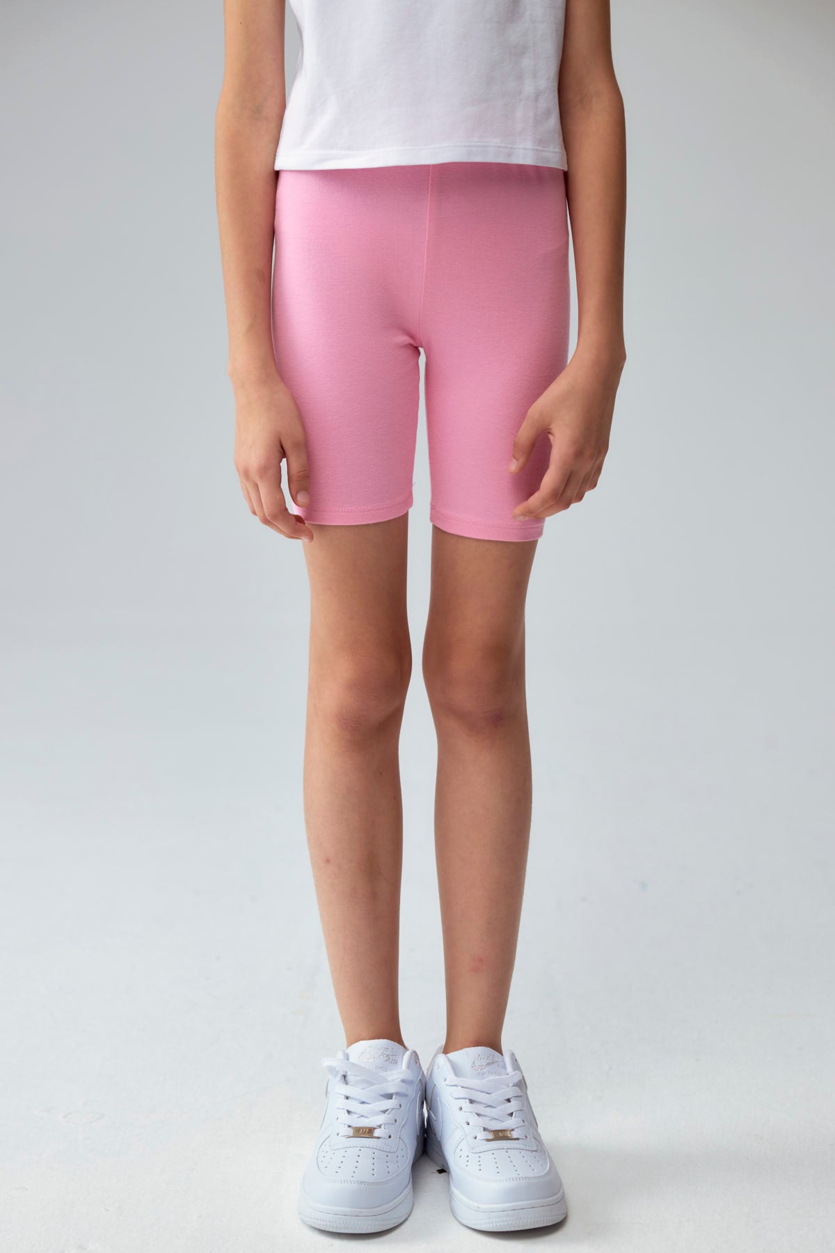 Calza niña biker turquesa con estampado de corazones pequeños en varios colores