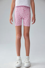 Calza niña biker rosado con estampado de íconos en fondo claro