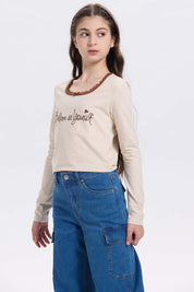 Polera beige niña con Aplicación Believe in Yourself