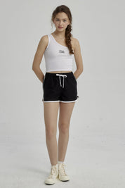 Short de baño niña liso negro con cordón blanco y ribetes blancos detalles simples sin estampa