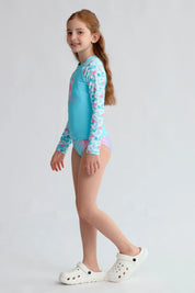 Traje de baño niña verde con polera UV y estampado de flamencos en fondo aqua