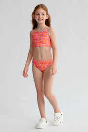 Traje de baño niña fucsia con estampado de hojas y espalda cruzada