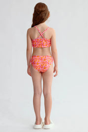 Traje de baño niña fucsia con estampado de hojas y espalda cruzada