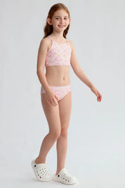 Traje de baño niña rosado con estampado floral y espalda cruzada