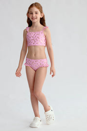 Traje de baño bikini niña rosado con estampado dorado de estrellas y volantes en los tirantes