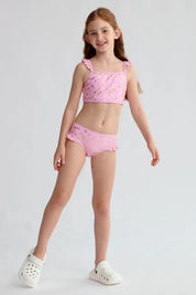 Traje de baño bikini niña rosado con estampado dorado de estrellas y volantes en los tirantes