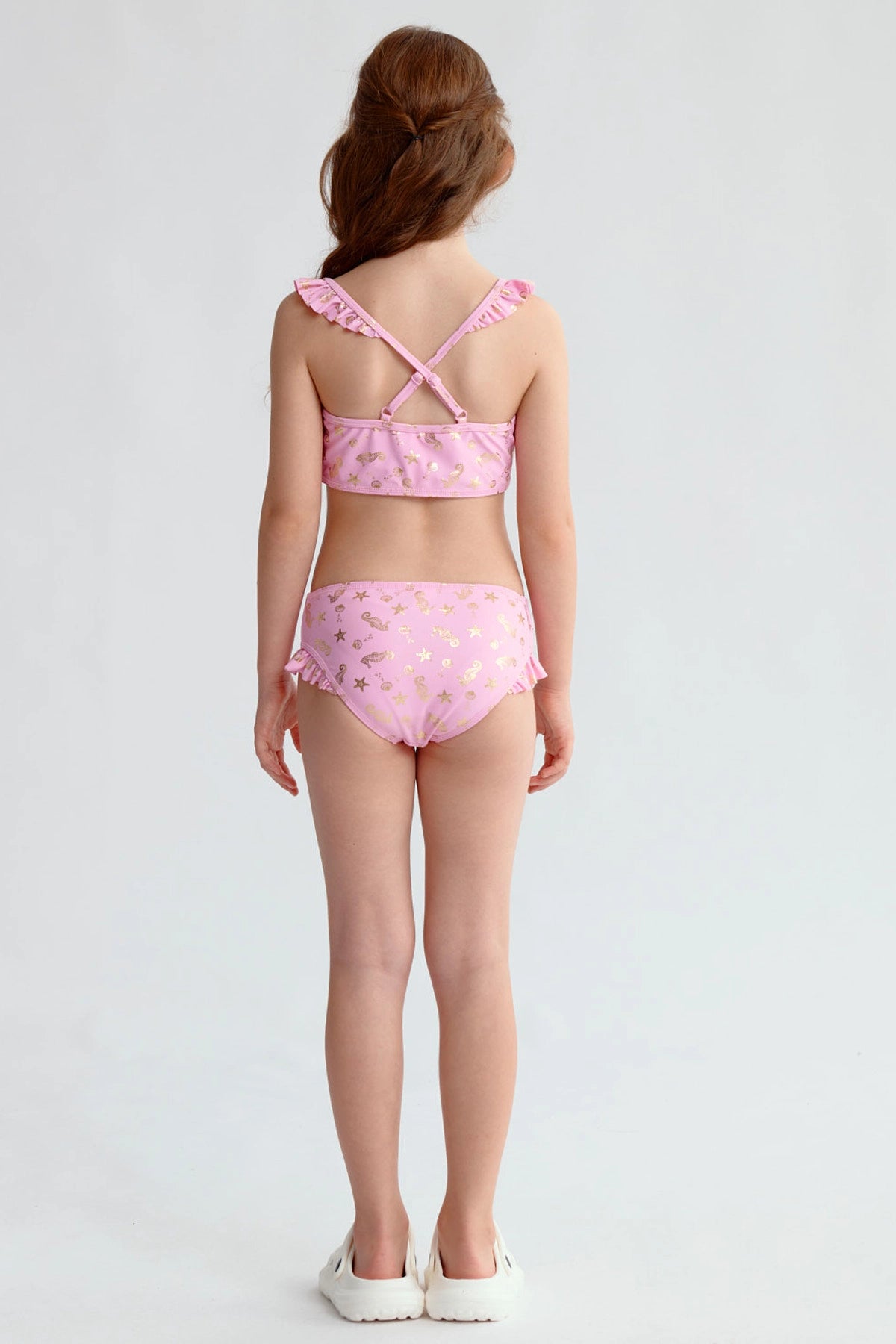 Traje de baño bikini niña rosado con estampado dorado de estrellas y volantes en los tirantes