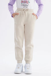 Pantalón buzo jogger beige niña con cintura elástica y bolsillos laterales lisa y cómoda ideal para el día a día