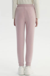 Pantalón jogger rosado para niña con cintura elástica y cordón liso sin estampa ajuste cómodo y bolsillos laterales