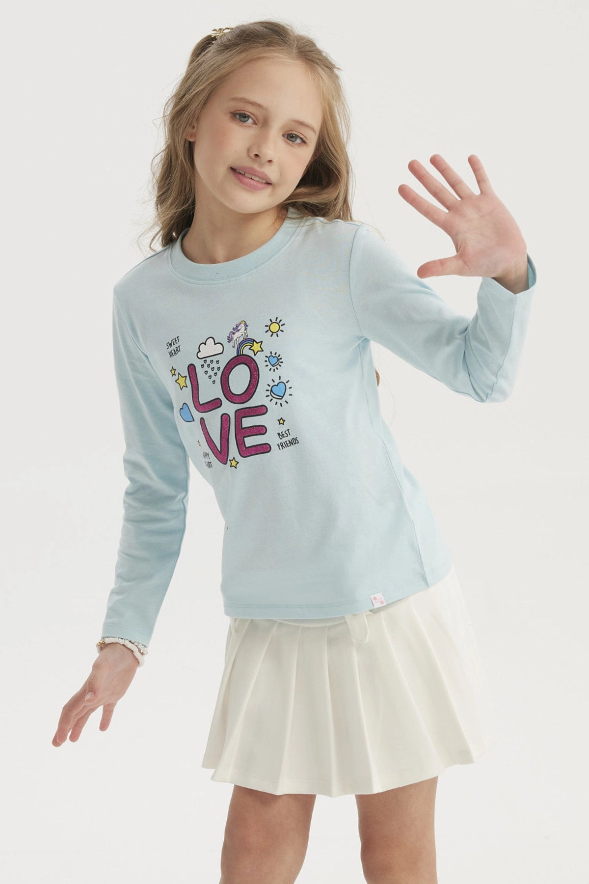 Polera niña celeste con estampa LOVE en letras grandes y coloridas con estrellas y corazones pequeños en el centro