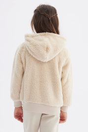Polar niña beige con capucha y textura peluda cierre frontal y bolsillos delanteros diseño liso cómodo y abrigador