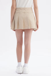 Falda beige para niña con slip integrado diseño plisado cinturón ajustable detalle en el lado sin estampa lisa