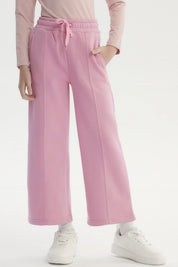 Pantalón buzo niña rosado de pierna ancha con cintura elástica y cordón ajustable diseño liso sin estampado