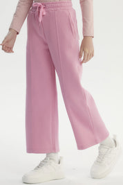 Pantalón buzo niña rosado de pierna ancha con cintura elástica y cordón ajustable diseño liso sin estampado